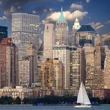 New York's waterfront skyline and a sailboat on the river