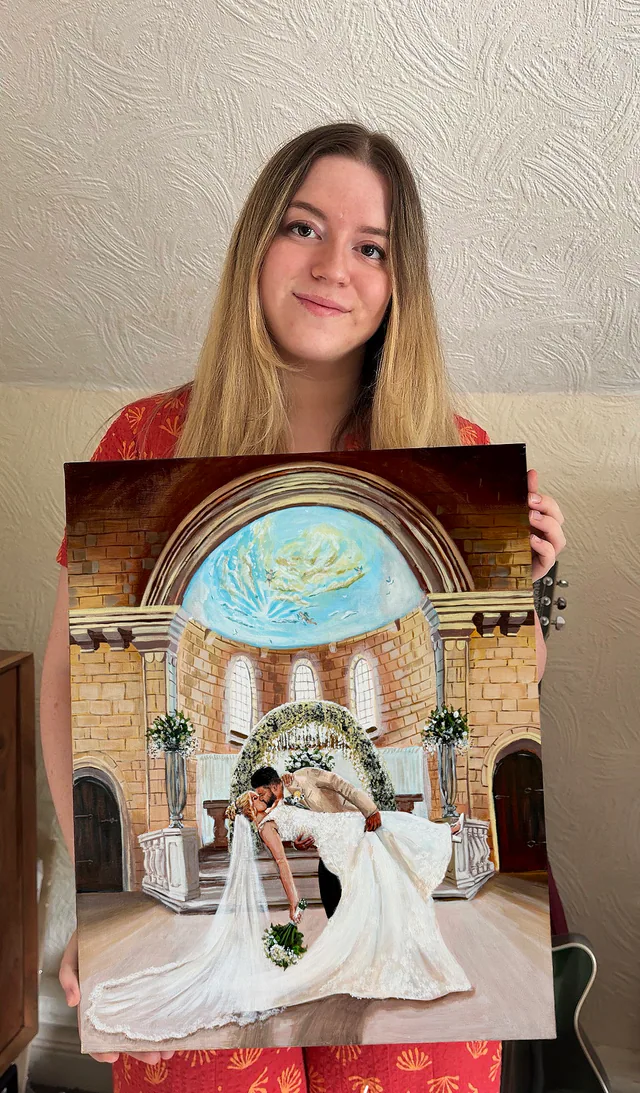 Wedding artist holding a detailed painted ceremony scene