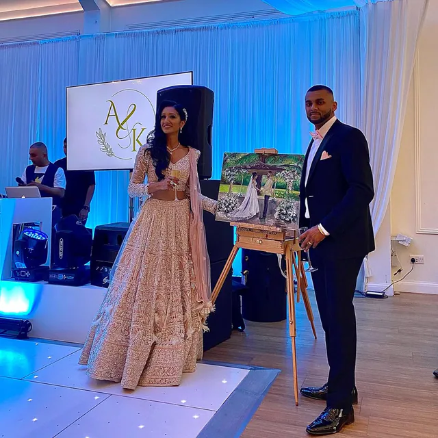 Newlyweds and their artist with a live reception painting