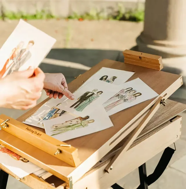 Wedding illustrator selecting hand-painted guest portraits