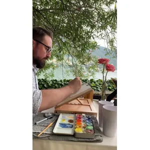 Andrea Spinelli painting live guest portraits in watercolour during a Lake Como wedding.