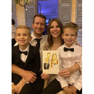 Family with two children holding their finished live watercolour wedding portrait.