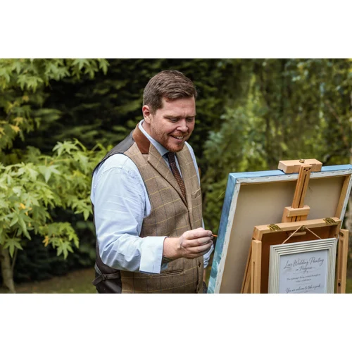 Profile photo of Tom in live painting setup with easel and signage.